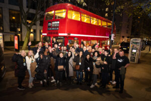 Kuba 20:30 Club members stand together outside a Routemaster bus in November 2023