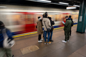 Kuba team mates gather on a London underground platform as a train speeds past
