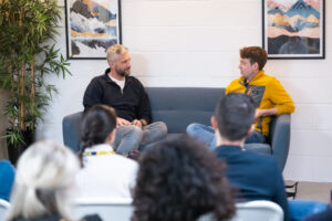 Kuba CEO Aaron Ross sits on a sofa with Laurence Carver from Blink for a fireside chat