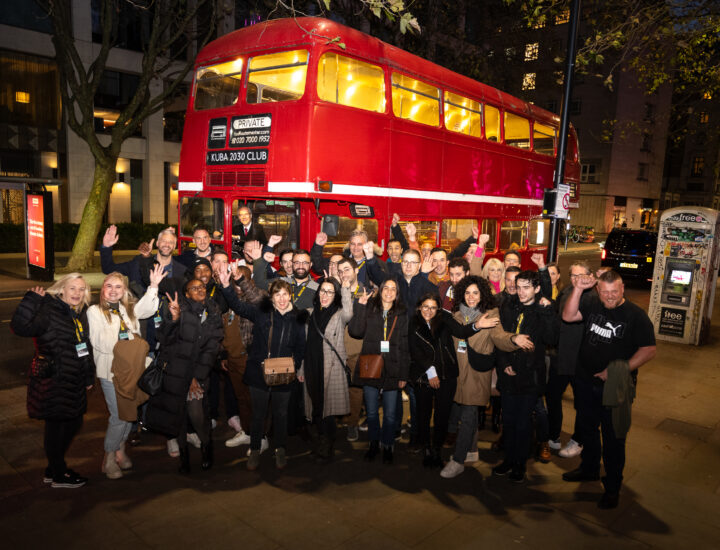 Kuba 20:30 Club team members outside a Routemaster bus in London