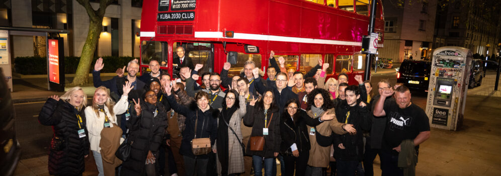 Kuba 20:30 Club team members outside a Routemaster bus in London